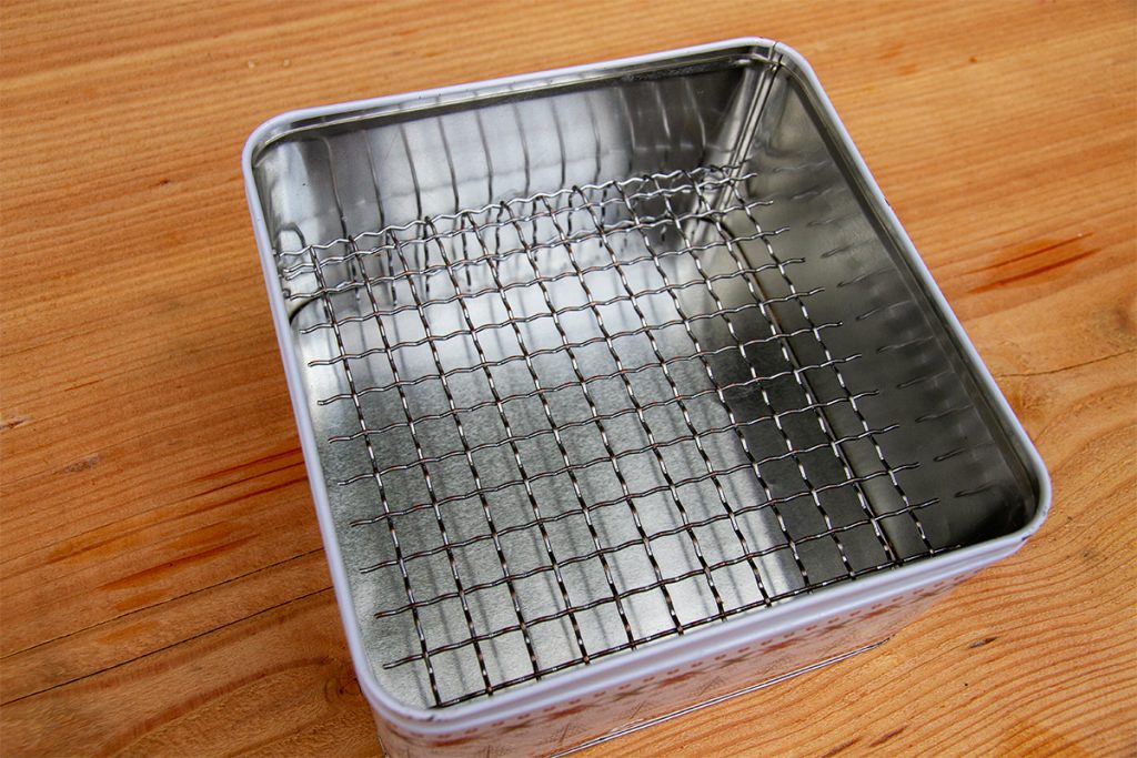 wire rack in a biscuit tin smoker