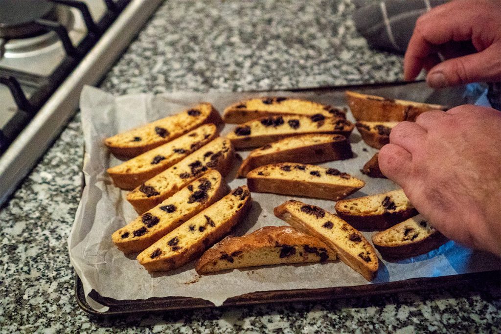 laying slices of biscotti on a baking tray for the second bake